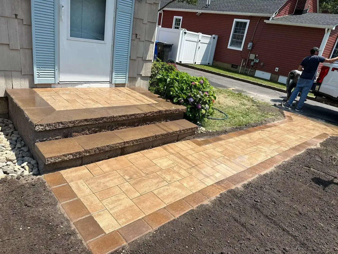Decorative concrete front steps and a matching patterned walkway